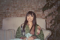 a woman sitting on a couch with a blanket